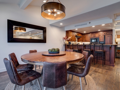 Gather around the handsome round dining table for memorable meals with loved ones, then step into your fully-equipped kitchen to whip up your favorite dishes in this open, inviting space.