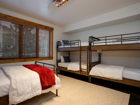 Sleep soundly in your cozy bunk room, where crisp linens and thoughtful details create a snug retreat for restful nights after mountain adventures.