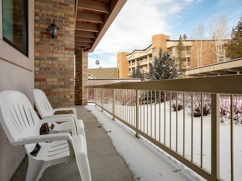 Winter views of snow-dusted grounds and neighboring buildings from your private outdoor space, perfect for crisp mountain mornings.