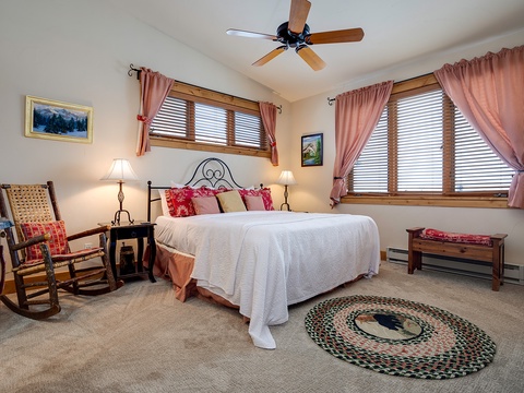 Drift off to sleep in this cozy bedroom with a plush bed, charming rocking chair, and a gentle ceiling fan keeping you comfortable all night long.