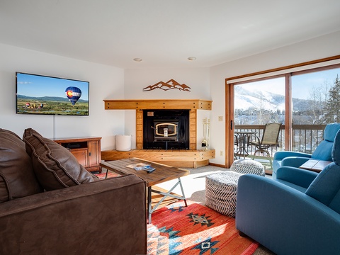 Sink into comfort with cozy seating, a warm fireplace, and stunning mountain views through your private balcony—perfect for unwinding after an adventure-filled day.