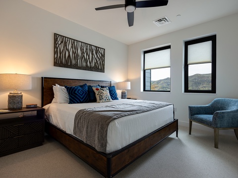 Sink into crisp linens and unwind in your peaceful retreat, where modern mountain charm meets comfort. Gentle ceiling breezes and twin windows frame the natural beauty just beyond your door.