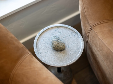 Settle into your cozy seating nook where natural textures meet modern comfort—a perfect spot to unwind with a book or morning coffee.