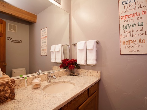 Your private bathroom offers fresh towels, a granite vanity with ample counter space, and uplifting décor to brighten your morning routine.