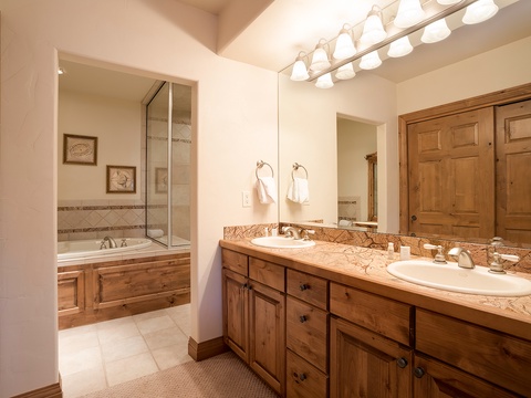 Enjoy your spacious bathroom with a double vanity and elegant granite countertops, complemented by a soaking tub and walk-in shower for ultimate relaxation.