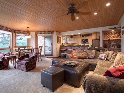 Unwind in your spacious living area, where warm wood ceilings and plush seating invite you to relax after a day of adventure. Enjoy lake views and seamless flow to your dining space and fully-equipped kitchen.