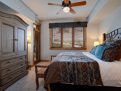 Sink into crisp linens and plush pillows after your day of adventure. Your peaceful bedroom retreat features classic mountain charm with warm wood accents and soft, natural light filtering through plantation shutters.