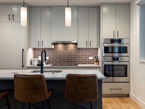Step into your sleek, modern kitchen where everything you need is at your fingertips. Gleaming appliances, stylish pendant lighting, and an inviting island make this the perfect spot to whip up a meal or enjoy your morning coffee.
