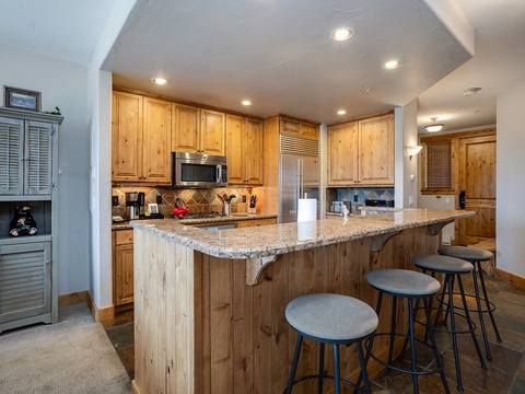 Gather around the spacious granite island for breakfast with mountain views through the windows or prep tonight's dinner with top-notch appliances and abundant counter space.