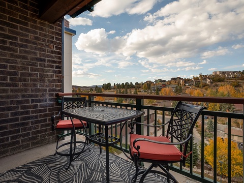 Sip your morning coffee on this charming balcony, overlooking vibrant autumn foliage and mountain town scenery. The perfect perch to plan your day's adventure or simply soak in the peaceful atmosphere.