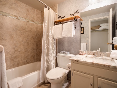 Your private bathroom offers a relaxing tub-shower combo, plush towels, a marble vanity, and rustic touches that make freshening up feel like a retreat.