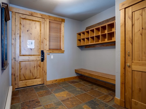 A well-organized mudroom greets you with warm wood tones, built-in storage cubbies for your gear, and a cozy bench where you can sit and unwind after exploring.