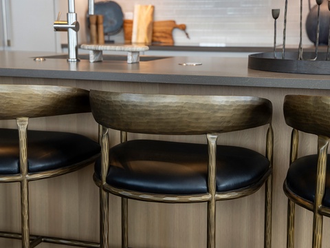 Settle into stylish comfort at your kitchen island, where sleek bar seating and modern design invite morning coffee rituals and evening conversations.
