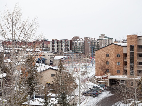 Snow-dusted neighborhood near the property, with nearby buildings and winter scenery creating a charming seasonal backdrop.