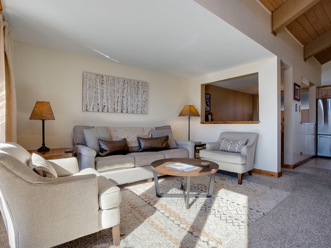 Unwind in your inviting living space where soft natural light, plush seating, and warm wood accents create the perfect retreat after a day of adventure.