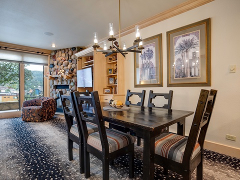 Gather around your private dining table beneath warm lighting, with cozy seating and charming décor welcoming you home after exploring the surrounding mountains.