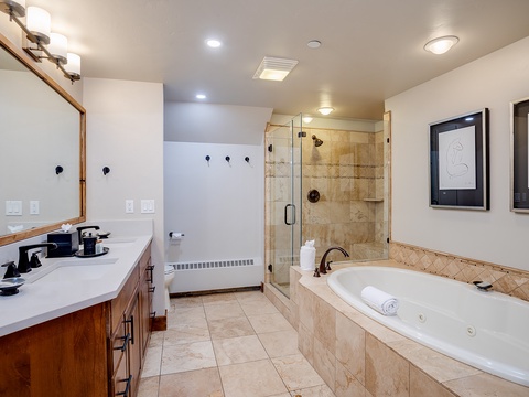 Soak away your cares in your private jetted tub, or refresh under the spacious walk-in shower with elegant tile and glass enclosure.