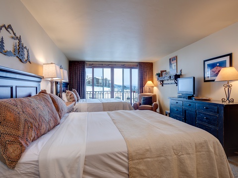 Sink into plush bedding and wake up to stunning mountain vistas framed by your balcony. Your alpine retreat awaits with elegant furnishings and warm lighting for ultimate relaxation.