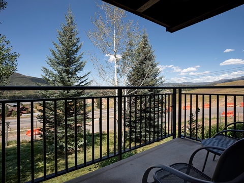 A peaceful mountain setting with tree-lined streets and open land, offering a quiet retreat near natural surroundings.