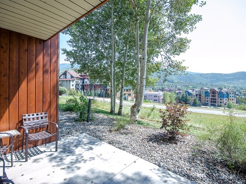 A peaceful ground-floor patio framed by towering aspens, offering sweeping mountain and valley views—perfect for morning coffee or quiet mountain evenings.
