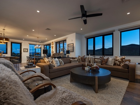Sink into plush seating and watch twilight paint the mountains beyond your windows—this open-concept living space blends warmth, style, and stunning vistas for your ultimate mountain retreat.
