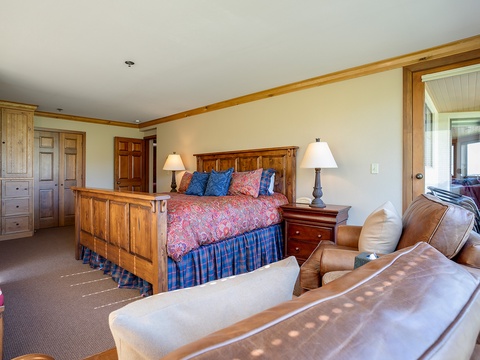 Unwind in your spacious master suite with handcrafted woodwork, plush bedding, and leather lounge seating—your private retreat after a day of adventure.