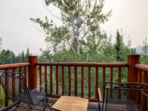 Sip your morning coffee on this private deck overlooking lush forest and mountain views, where every sunrise brings a sense of peaceful escape.