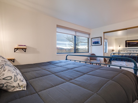 Unwind in your serene bedroom with mountain views framing your mornings and cozy beds awaiting your restful nights.