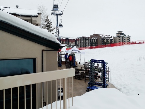 Ski-in convenience places the property steps from the slopes, with gondola access, ski storage, and snowy mountain views defining the winter resort setting.