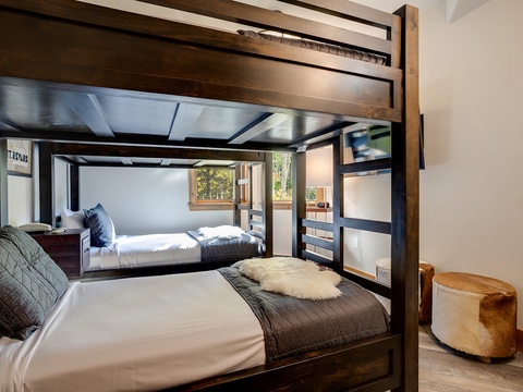 Sink into plush linens and wake to sunlit mountain views from your stylish bunk retreat, where rustic wood beams meet modern comfort perfectly.