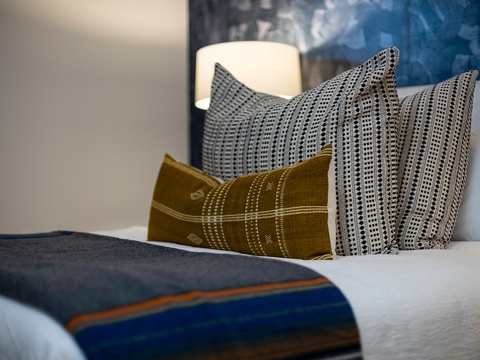 Sink into plush comfort with curated throw pillows layered over crisp white linens. Your restful retreat awaits with thoughtful touches that make this bed yours.