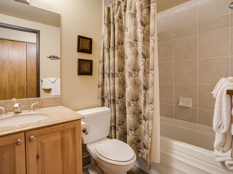 Step into your private bathroom with a tub-shower combo, soft towels, and warm natural tones that help you unwind after a day of adventure.