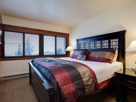 Sink into plush bedding and wake to soft natural light filtering through your private window. Your restful retreat features elegant furniture and warm bedside lamps creating the perfect atmosphere for relaxation.