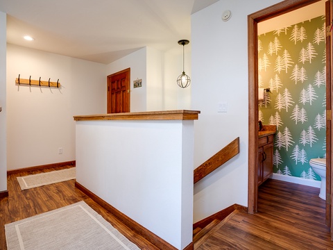 Step into your mountain retreat where warm wood tones and charming forest-inspired accents create a cozy, welcoming vibe the moment you arrive.
