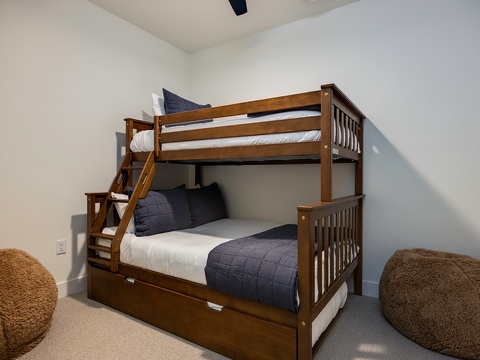 Your cozy bedroom features a sturdy twin-over-full bunk bed with soft linens and plush bean bag seating for relaxed moments together.