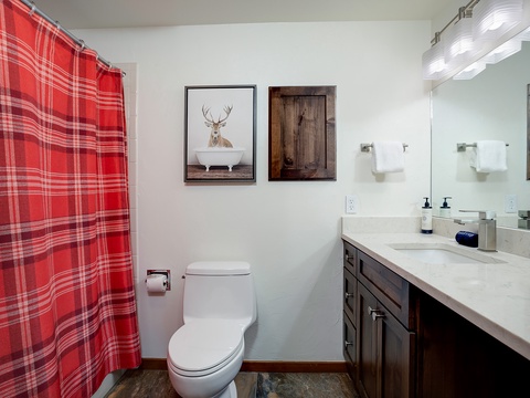 Your private bathroom blends rustic charm with modern comfort—enjoy fresh towels, quality fixtures, and thoughtful touches like playful artwork that make freshening up feel special.