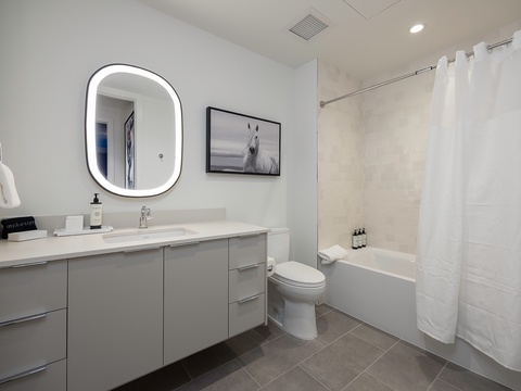 Step into your sleek, spa-like bathroom where clean lines meet modern comfort. Warm lighting, soft towels, and thoughtful touches create a calming retreat after exploring or unwinding by the tub.