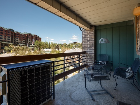 Your private balcony offers a peaceful retreat with comfortable seating and sweeping views of the surrounding resort area and natural landscape, perfect for morning coffee or evening relaxation.