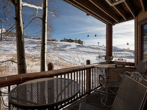 Covered terrace with ski slope views, gondola access, and mountain scenery. A tranquil alpine setting ideal for après-ski relaxation.