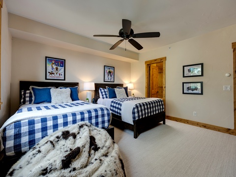 Drift off in comfort as the ceiling fan hums overhead, wrapping you in a cozy retreat with mountain lodge charm and vibrant pops of blue.
