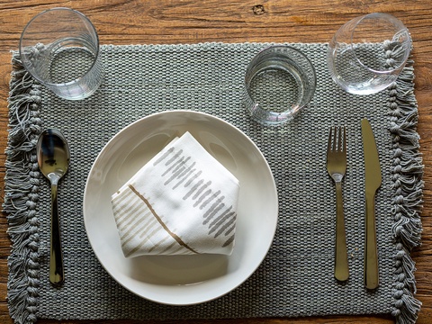 Picture yourself enjoying meals at this thoughtfully set table, where rustic wood and elegant glassware create a welcoming dining atmosphere during your stay.