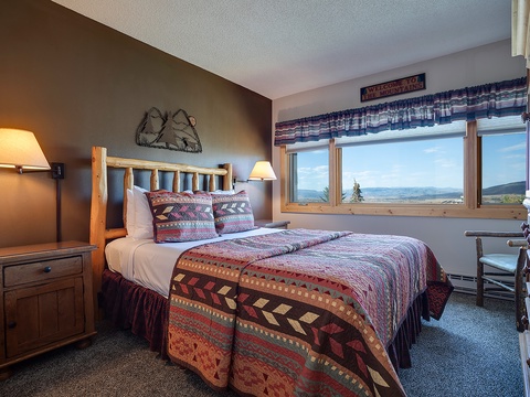 Wake up to sweeping mountain views from your cozy bedroom, where rustic lodge charm meets modern comfort. Sink into plush bedding and let the natural light fill your space.