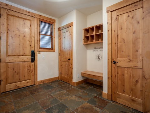 Step into your cozy mountain retreat through a charming entryway with rustic wood details, built-in storage cubbies, and a welcoming bench to settle in after your adventures.