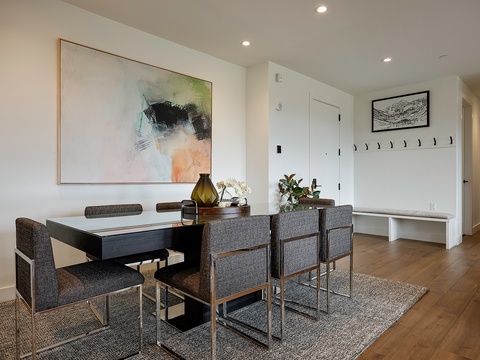 Gather around the sleek dining table for memorable meals together. Modern furnishings, tasteful art, and warm wood floors create an inviting space where you'll love sharing stories over dinner.
