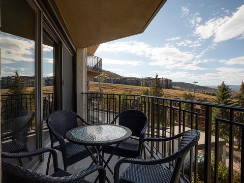 Enjoy morning coffee on your private balcony overlooking rolling hills and mountain vistas—a peaceful spot to plan adventures or simply soak in the tranquil surroundings.