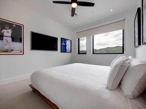 Drift off in crisp linens while mountain peaks frame your window—a serene retreat where comfort meets breathtaking natural beauty.