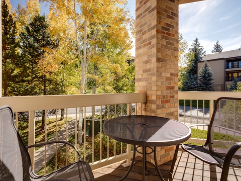 Step onto your private balcony with cozy seating and soak in the vibrant autumn foliage—golden aspens and evergreens create a peaceful mountain retreat perfect for your morning coffee.