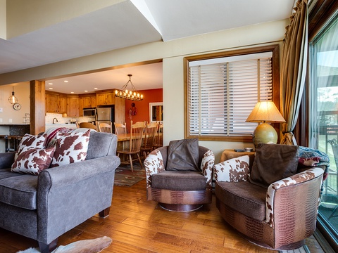 Sink into cozy seating with rustic charm as you enjoy an open floor plan connecting your living room, dining area, and fully equipped kitchen—perfect for gathering together.