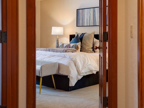 Step into your serene retreat where plush linens, stylish décor, and warm lighting create the perfect haven for restful nights and peaceful mornings.