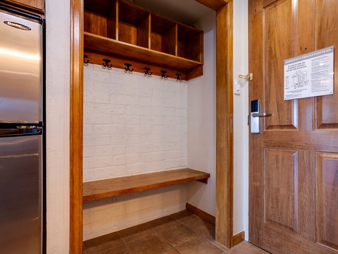 Hang your coats and stash your gear in this welcoming entryway nook. Wooden hooks, cubbies, and bench seating keep everything organized so you can settle in and relax.